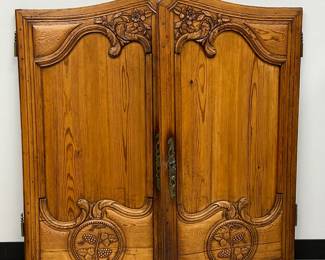 A pair of antique European finely hand-carved wooden doors from an armoire, 19th century, to hang as wall art. The doors display acanthus scrolls, flowers, and grapes in carved relief and each measures 43" x 26"
