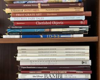 Reference and art books including The Catalog of American Antiques, A History of Postcards, The Foremost Guide to Uncle Sam Collectibles, Fruit Crate Art, Cooper-Hewitt Museum Boxes, Pottery, Toys & Games; Walt Disney's Bambi The Story and the Film, The Art of Walt Disney, Paper Americana A Collector's Guide, and Sewing Tools & Trinkets