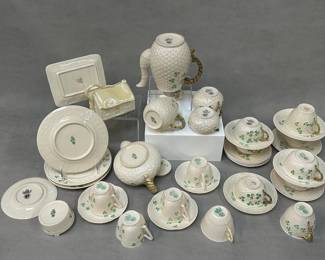 Another view of the vintage Belleek porcelain including a 16-oz Shamrock jug or pitcher, 3 Shamrock salad plates, a Belleek Pottery Shamrock coffee pot, teapot, sugar, and creamer; a vintage Belleek "Shamrock" open butter tub, 4 Belleek Pottery Harp Shamrock cups with 3 matching saucers, 1 Belleek Ireland Tridacna cup, 2 Belleek Shamrock teacups, 5 Belleek Shamrock flat cups, 11 Belleek Ireland porcelain saucers, and a vintage Belleek Pottery figural cheese dish with lid