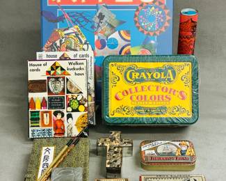A Crayola Collector's Colors Limited Edition tin, a vintage metal tin for Lofthouse's Original Fisherman's Friend lozenges, a vintage Jaques & Son Reversi game box, a a traditional Chinese calligraphy set box with two brushes and a stone for grinding ink, a kaleidascope, the book Kites published by Brockhampton Press, a small wooden box decorated with imagery from an early tarot card, a vintage Charles Eames House of Cards picture deck of cards, also known by the German name Wolkenkuckuckshaus