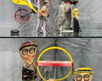 Vintage toys including a rare 1890’s Gilbert weighted balance bicycle racer tin toy measuring 8” W x 6.5” H with original paint in good condition, a Marx Harold Lloyd tin litho Funny Face Walker toy, and an antique Wolverine Shoot-A-Loop litho tin marbles game