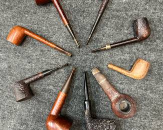 A collection of 9 vintage smoking pipes including a Dunhill Shell briar smoking pipe, a Madison 1014 Algerian Briar France pipe, an Italian Castello Sea Rock Briar smoking pipe, a Stanwell 91r briarwood tobacco pipe, and more