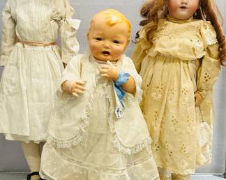 A 27-inch tall Handwerck Halbig mold 119 bisque head doll wearing earrings, eyelet lace dress and carrying a handbag, marked 119 - 13 Handwerck Germany Halbig, a 21-inch Effanbee Bubbles blonde doll, with original tagged dress and undies, and a 30-inch tin head doll marked "Germany 7" on one side and "Minerva" on the other