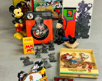 Vintage Disney Mickey Mouse collectables and memorabilia including a vintage Kurt Adler Disney wooden pull-string ornament featuring Mickey Mouse as a cowboy riding a horse, a vintage tin lithograph sparkler toy featuring Mickey Mouse and Felix the Cat,    vintage lead or cast iron Disney figurines featuring Mickey and Minnie Mouse and Pluto, a vintage Disney Mickey Mouse metal lunch box, a vintage vintage Disney Mickey Unlimited ballpoint pen in original box, manufactured by Kreisler; a Mickie Mouse by Thanks for Children eau de toilette in original box, and more