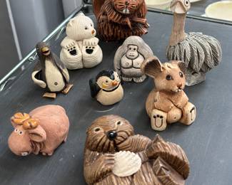 Artesania Rinconada pottery animal figurines including a beaver, a bear, a gorilla, an ostrich, penguins, a rabbit, a moose, and an otter holding a shell