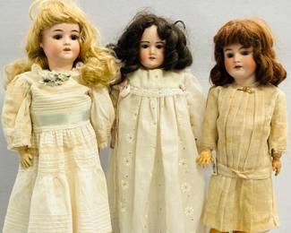 Antique dolls and vintage dolls including a 22-inch tall Heinrich Handwerck Simon & Halbig 3 bisque head doll, earrings in pierced ears, wearing cream-colored dress, and socks and shoes