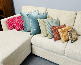 Another view of the Walter E. Smithe 2-piece sectional with a chaise lounge and some brightly colored decorative throw pillows.