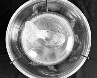 A view looking down at the top of the stunning Lalique "Igor" pattern crystal caviar serving bowl. The set includes a large clear glass bowl with a dolphin tripod base designed to hold crushed ice, a frosted glass insert dish for the caviar, and a lid topped with a dolphin finial. The insert dish is held in place by a silver-plate metal frame.  The piece was designed by Marie-Claude Lalique in 1969 and is signed "Lalique France"