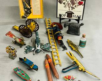 Vintage toys and games including a "Spoon Tricks" dexterity game, a vintage Louis Marx & Co. tin lithograph wind-up toy, often known as "Smokey Joe the Climbing Fireman", a bird-shaped whistle, two tin litho alligator toys, a wind up tin dragonfly, a small cast iron horse that's marked Spark Plug on one side and Barney Google on the other, a vintage top hat themed dexterity game, and more
