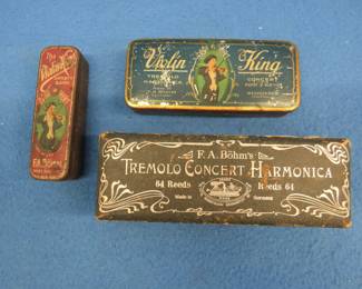 Lot 147. Two old F.A. Bohm empty metal harmonica tins and one old F.A. Bohm empty cardboard hinged Tremolo Concert Harmonica box