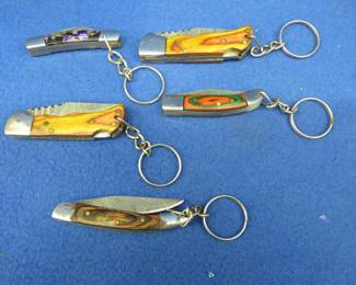 Lot 220. Five new folding pocket knives, four are Damascus, with no markings