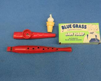 Lot 149. Jaw Harp in the box with papers, old metal Kazoo, plastic flute. and an ice cream cone whistle.