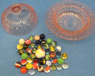 Lot 34. Marbles in a glass-covered pink candy dish