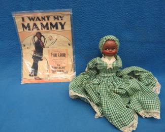 Lot 244. Black doll that sits flat and old black face sheet music