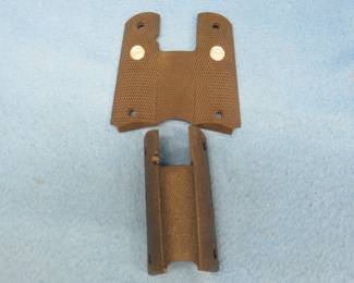 Lot 246. Two wrap-around Colt 1911 grips. Radical Concepts with a silver medallion and a Supreme.