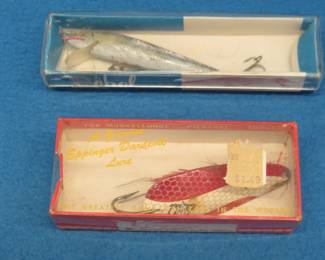 Lot 312. Vintage Rebel 3 1/4" minnow bait with the box in excellent condition, and an Eppinger 3" Dardevle in the box also in excellent condition