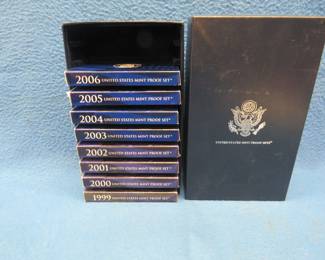 Lot 126. Eight US Mint proof sets in a display box. Each set contains regular denomination coin set and a state quarter set.
