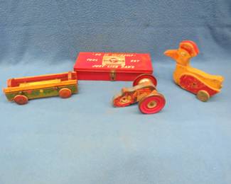 Lot 56. Three vintage wooden pull-toys and a child's toolbox with a saw