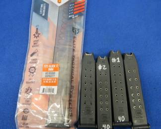 Lot 281. Four 14-round Glock 40 cal. magazines and one 40-round Glock 9mm magazine