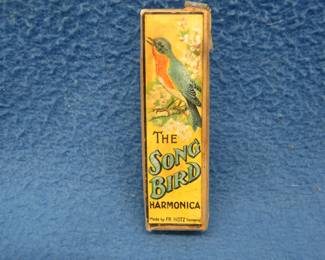 Lot 87. Fr. Hotz "The Songbird" 10-hole diatonic harmonica in the key of g. in the box. Sounds great. Box is in fair condition.