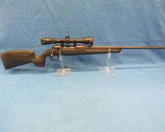 Lot 14. New-in-the-box Savage Axis XP .223 bolt-action rifle with a Weaver 3-9x scope. S/N R351723. Black matte synthetic stock. Includes original box and manual.