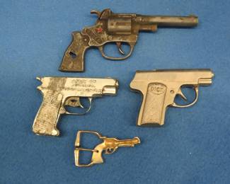 Lot 202. Three vintage metal toy guns for parts or repair and a child's belt buckle