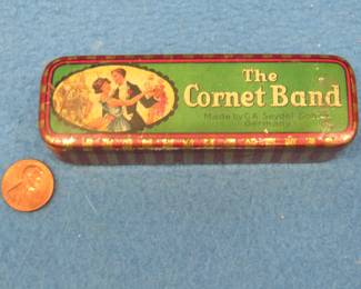 Lot 267. Seydel The Cornet Band empty tin harmonica box. Music Master 12-hole harmonica made in Japan Some holes do not have sound.