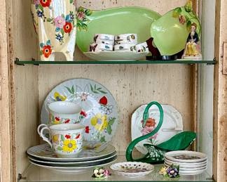 The sandwich and tea plates on the third shelf are sold.