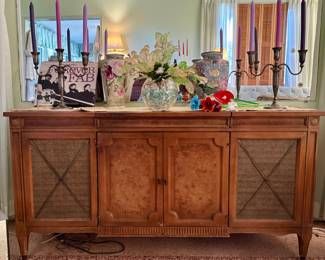 The candleholders, glass flowers and flowered vase on the right were sold.