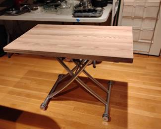 Contemporary folding table.  Castors on feet.  