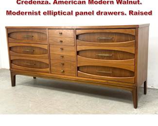 Lot 267 JOHNSONCARPER Dresser Credenza. American Modern Walnut. Modernist elliptical panel drawers. Raised 