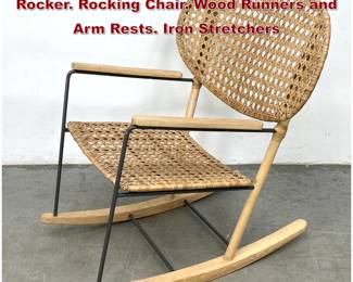 Lot 476 IKEA Gronadal Woven Caned Rattan Rocker. Rocking Chair. Wood Runners and Arm Rests. Iron Stretchers
