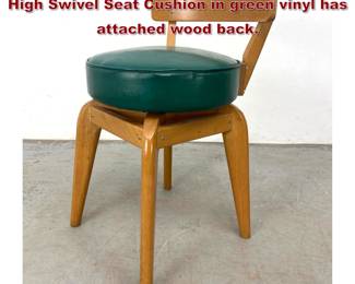 Lot 510 Low Back Modernist Wood Chair. High Swivel Seat Cushion in green vinyl has attached wood back. 