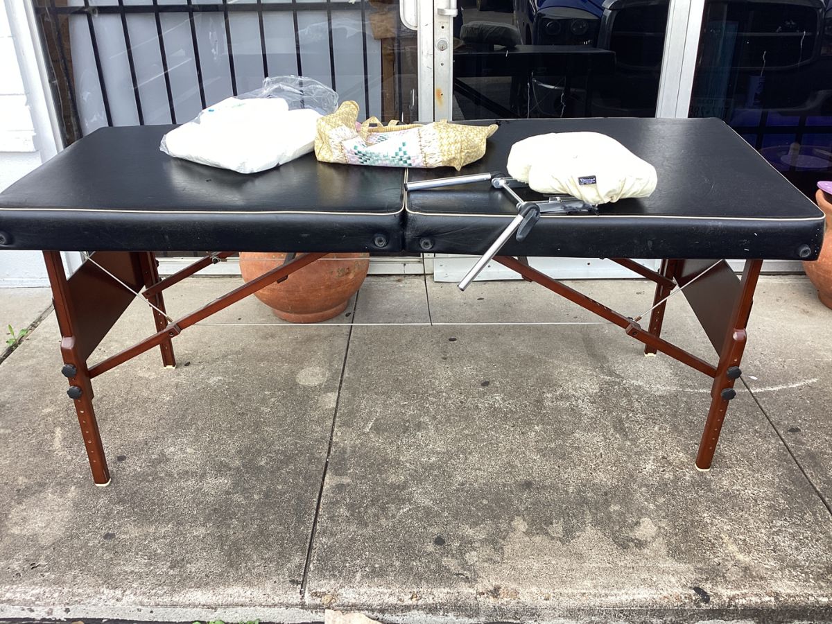 Folding massage table with head rest