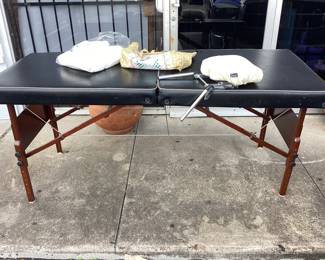 Folding massage table with head rest