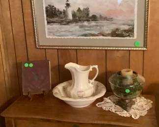 Antique oak cabinet with old pitcher and bowl with beautiful picture above.