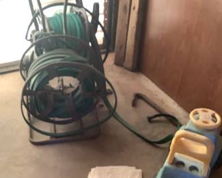 Water hoses and child’s pedal car.