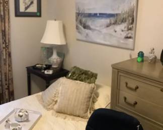 Full view of twin bedroom with old with decorative pillows.