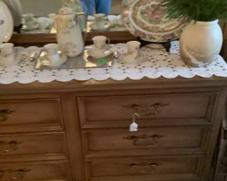 Dresser in den with several items.