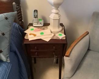 Antique mahogany drop leaf table with chair in bedroom.