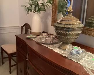 Showing the large brass pot and flower arrangement on buffet.