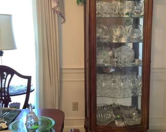 Gorgeous walnut curio cabinet with lighted cabinet with glass shelves.