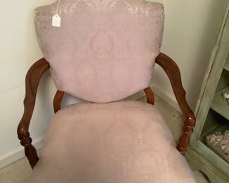 Antique chair with rose colored fabric.