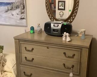 Green chest in twin bedroom with old radio and c.d. Player.