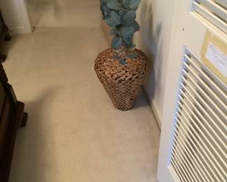 Wicker bottle with greenery.