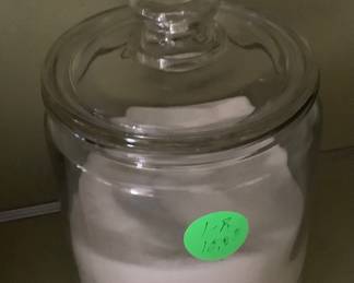A glass jar holding sugar.