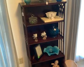 The mahogany cabinet with glassware.