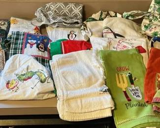 Assortment of Kitchen Oven Mitts, Towels, and Apron