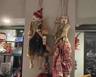 antique Burmese hand-carved wooden puppet marionettes, likely depicting traditional male and female figures. 