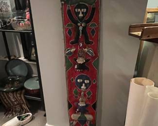 decorative beaded wall hanging or sash, often associated with African Yoruba art, frequently featuring figures like monkeys, ducks, fish, and snakes. 